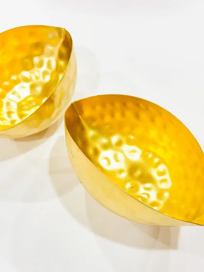 Here is another view of our leaf-shaped urlis. Their golden, hammered finish catches the light beautifully.