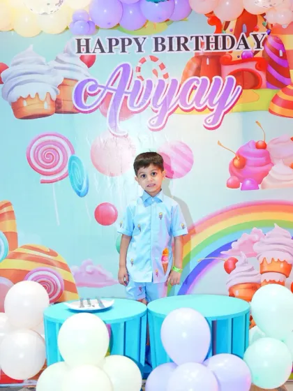The birthday boy stands proudly in front of his personalized candy-land backdrop. We ensure the birthday star is the center of attention.