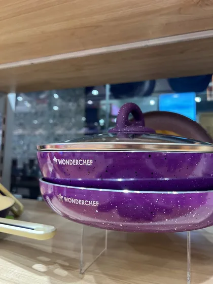 Clean, professional product shots are essential for e-commerce. This image for Wonderchef showcases their purple cookware set, using clear lighting and simple stacking to emphasize the product's design and color for online catalogs.