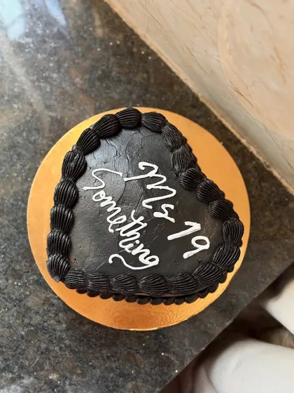 A top-down view of the black heart-shaped chocolate cake, perfect for a chic and modern celebration.