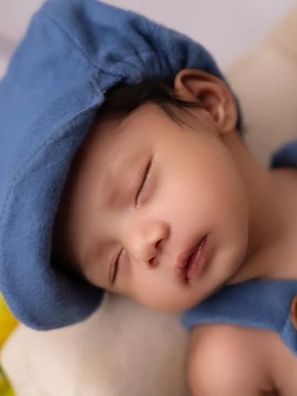 A detailed close-up of the newborn's face, showing his peaceful sleep. I use soft lighting to highlight their delicate skin and features.