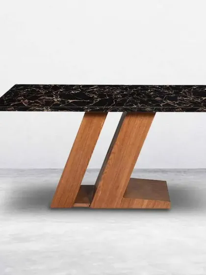 A unique dining table design combining a black marble top with a Z-shaped wooden base.