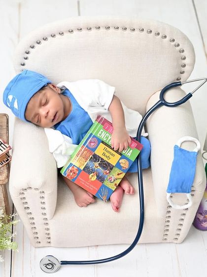 The doctor is in, and he's taking a nap. This adorable 'future doctor' theme, complete with a tiny lab coat and stethoscope, is a creative and fun way to capture your newborn.