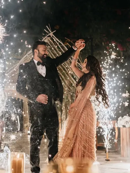 This is what a magical sangeet night feels like. I use elements like cold pyrotechnics and dramatic lighting to frame your first dance, turning it into a show-stopping moment straight out of a movie.