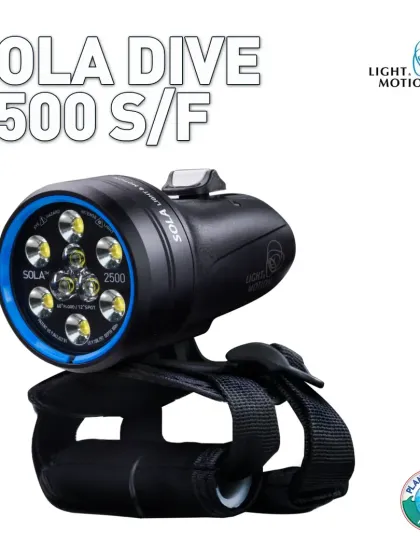 The Sola Dive 2500 S/F light by Light & Motion, shown with its comfortable hand strap. This compact yet powerful light is a favorite for its versatility, offering both a tight spot beam for distance and a wide flood beam for general exploration or video.