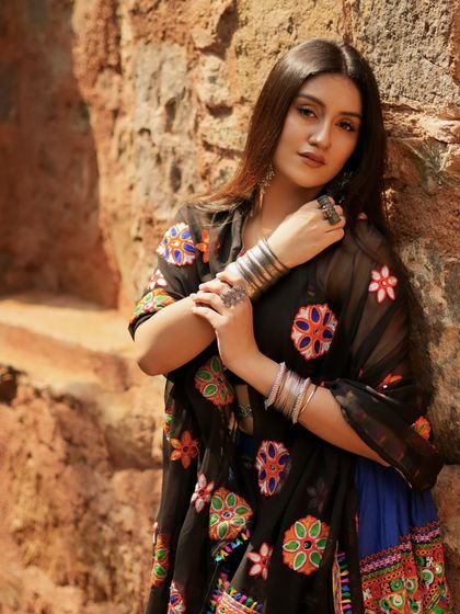 A confident pose, showing off the stacked silver bangles.