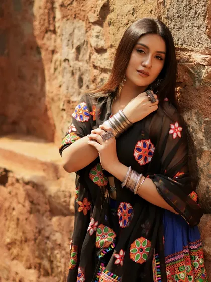 A confident pose, showing off the stacked silver bangles.