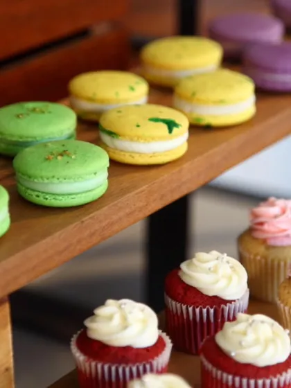 A close-up of our colourful macarons and mini cupcakes. We offer a variety of flavours and designs, from pistachio macarons to classic red velvet cupcakes, all beautifully crafted.