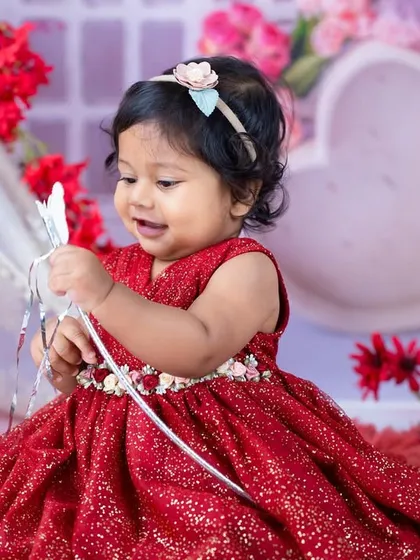 A playful moment captured during the red princess session. These candid shots are full of life and personality.