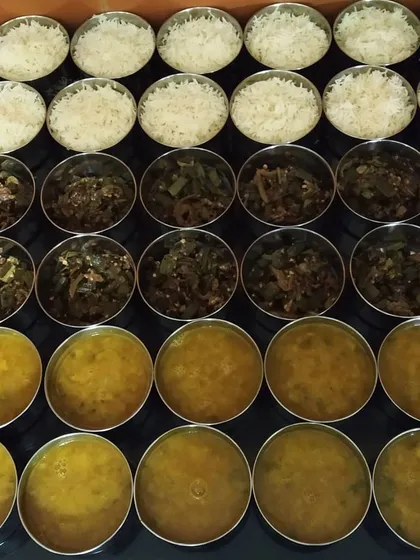 Preparing lunch orders for offices in Greater Noida. We ensure every meal, whether for home or office, is prepared with the same attention to hygiene and homemade taste. Here you can see bhindi sabzi, dal, and rice ready to be packed.