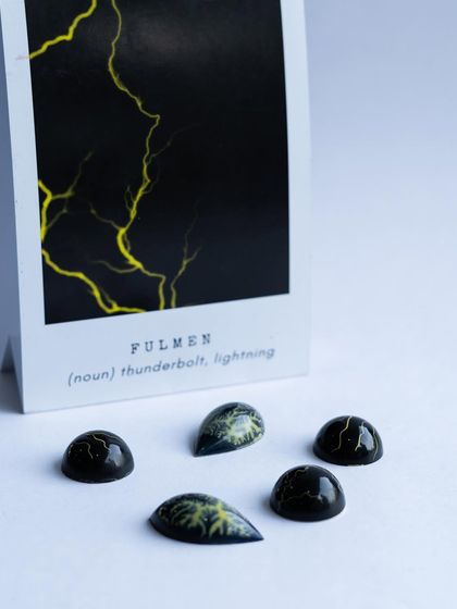 Inspired by lightning, these "Fulmen" bonbons showcase advanced coloring techniques to capture the dramatic patterns of nature in chocolate.