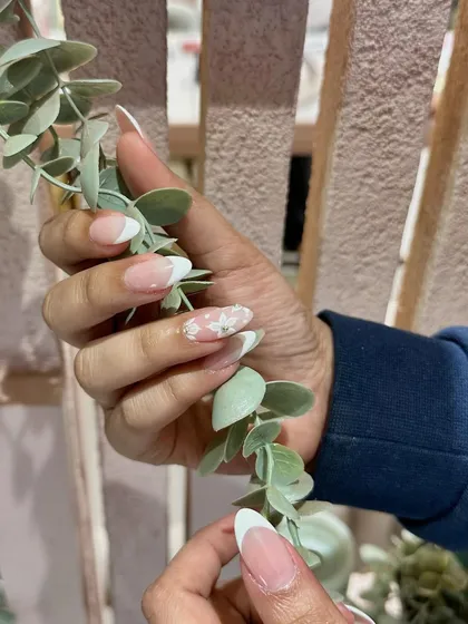 The perfect combination of classic and creative. A timeless French manicure with a touch of floral artistry.