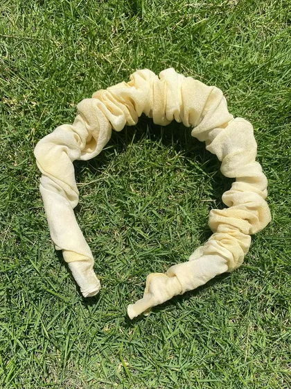 A close-up of the scrunchie headband. The soft fabric and natural dye are gentle on the hair, and the design is both comfortable and stylish.