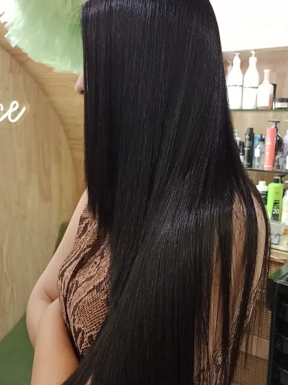 A side view of the sleek and straight finish after a Hair Botox and Olaplex treatment. The hair is perfectly smooth from root to tip.