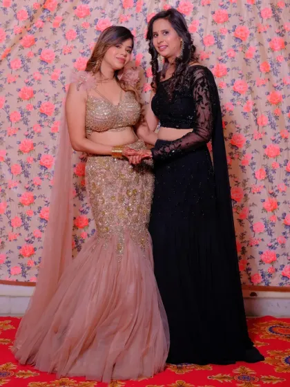 A happy client looking fabulous in a champagne-colored fish-cut lehenga with feather details. It's the perfect glamorous outfit for a friend's wedding or reception.