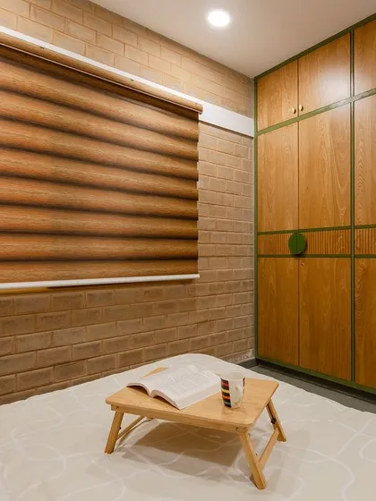 A bedroom with a custom-built wardrobe. The green circular handles provide a pop of color against the natural wood veneer.