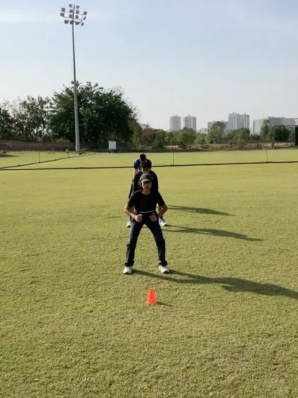 An athlete getting ready for a sled sprint. This drill is excellent for building acceleration power by adding resistance, forcing the body to produce more horizontal force with each step.