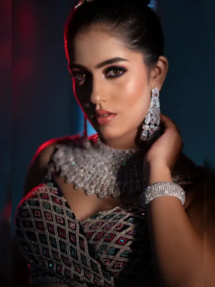 A modern and edgy bridal portrait using mixed lighting. The combination of red and blue light creates a vibrant and high-fashion feel.