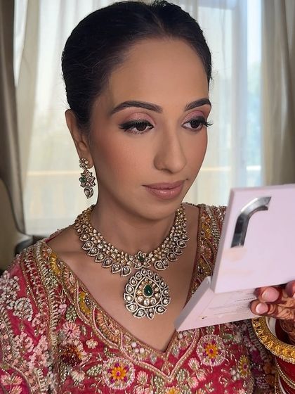 The bride admiring her soft and natural makeup look. My goal is to make my clients feel like the best version of themselves, especially when they want a more understated look.