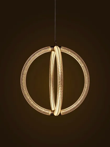 A close-up of the Luminora pendant against a dark background, its internal light source creating a warm and captivating glow.
