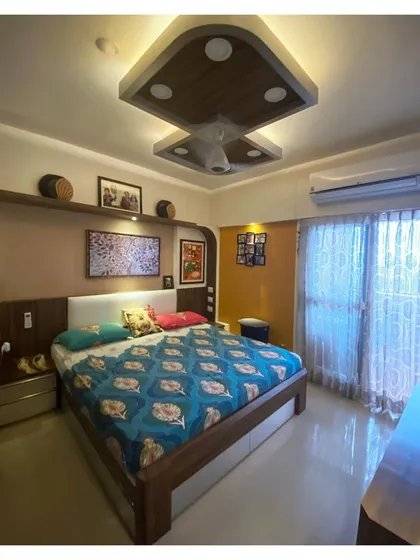 A wider view of the master bedroom, showing the bed and the natural light from the balcony. The design proves that even after six years, good design remains timeless.