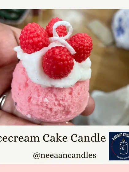 A close-up of our ice cream cake candle, showing the realistic texture of the ice cream scoop and the delicate raspberry toppings.