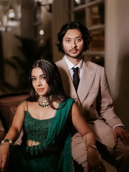 A powerful and elegant portrait of the bride and groom. Her sangeet makeup is glamorous and sophisticated, designed to look stunning in professional photos.