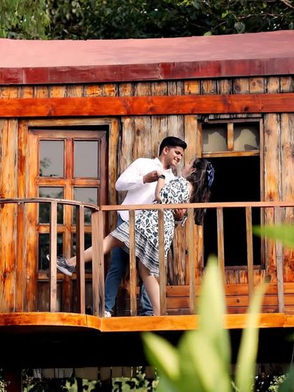 A fun and energetic lift on the treehouse balcony. I always encourage playful interactions to capture the couple's dynamic personality.