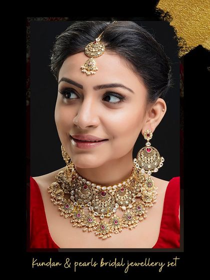 Enhance your bridal beauty with this stunning Kundan and pearls jewelry set. The choker is paired with oversized earrings and a maang tika for a complete and elegant look.