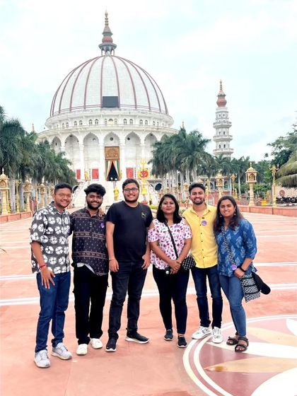 A duplicate of the group posing in front of the magnificent MIT World Peace Dome in Pune.