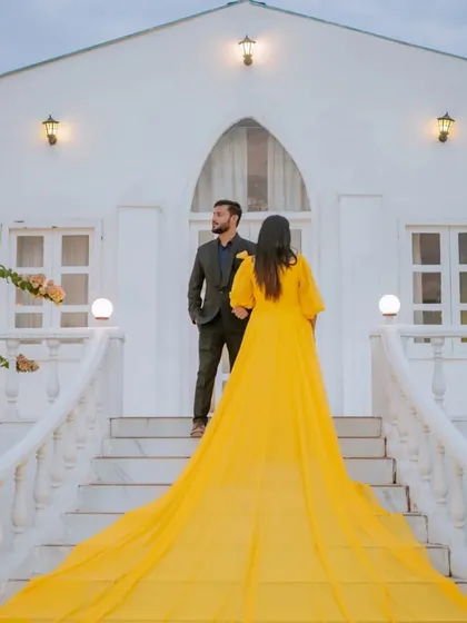 A classic, elegant pose in front of our special white chapel set. This setup is perfect for couples wanting a clean, minimalist, and modern pre-wedding aesthetic.