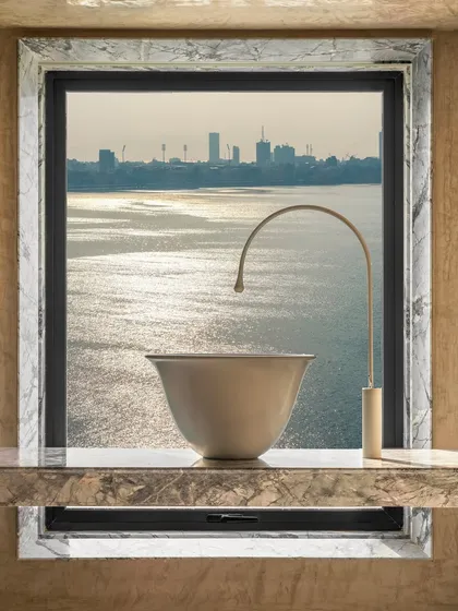 Details make the difference. For this sea-facing duplex, we used Grey Myst marble to frame the window, turning the view of the water into a living piece of art. The material itself tells a story.