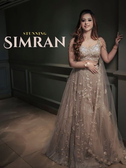 "Stunning Simran." A beautiful full-length portrait of the bride. The soft lighting and her graceful pose perfectly capture her elegance and the intricate details of her gown.