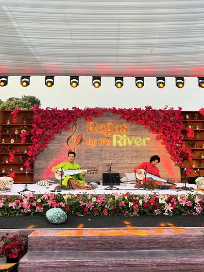 A wide view of the beautifully arranged "Ragas by the River" concert in Jim Corbett. I had the honor of performing alongside the legendary Ustad Amjad Ali Khan's family, a truly memorable experience in a serene setting.