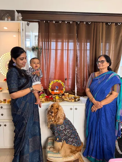 A three-generation family photo celebrating Janmashtami. Our family is complete with our two boys, human and furry.