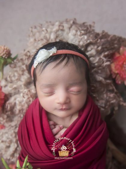 A close-up on this little one's face, showing their peaceful expression and tiny hands tucked in. These detailed shots are so precious to look back on.