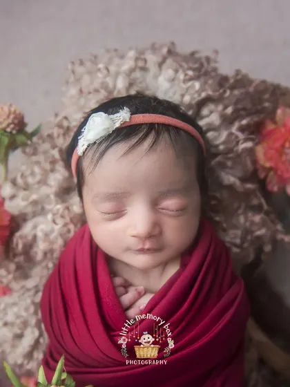 A close-up on this little one's face, showing their peaceful expression and tiny hands tucked in. These detailed shots are so precious to look back on.