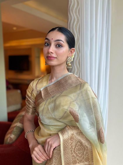 A simple and elegant look in a classic saree. This kind of portrait is perfect for showcasing timeless pieces where the focus is on the fabric's texture and the overall grace of the attire.