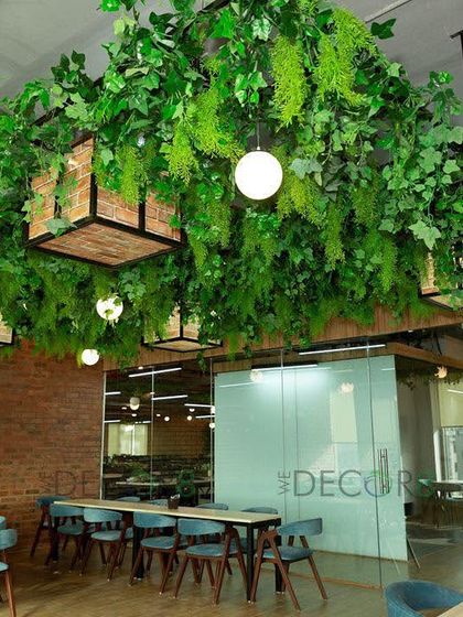We created this dense green canopy over a cafeteria space to make break times more refreshing. This hanging installation uses a mix of artificial foliage and integrated lighting, transforming the ceiling into a vibrant indoor jungle without taking up any floor space.