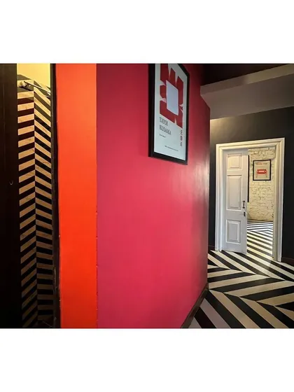 A hallway in the CoLive apartment, showing the use of vibrant color and pattern to manipulate a restrictive spatial matrix. This project is an exploration of creating generous social spaces within a load-bearing structure.