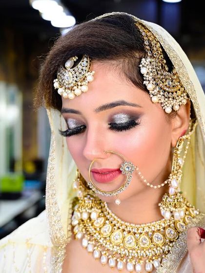 A close-up bridal portrait focusing on the stunning silver eye makeup and heavy kundan jewelry.