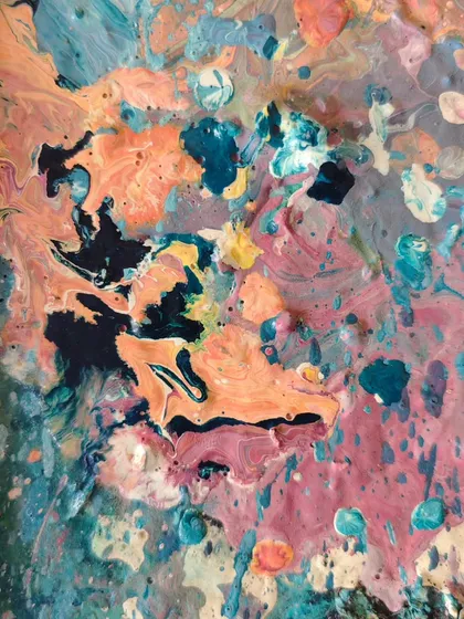An abstract swirl of leftover paint on a palette. Even our messes are beautiful, full of color, texture, and the energy of creation.