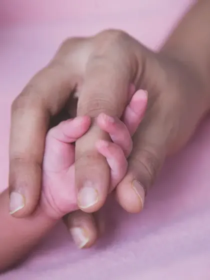 The simple, powerful image of a newborn's hand wrapped around a parent's finger. This shot beautifully captures the immediate bond and the delicate nature of your new baby.