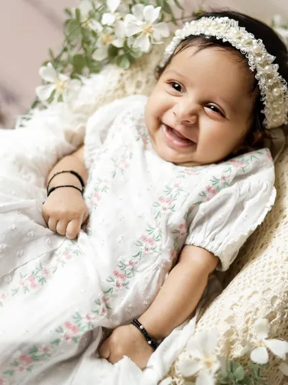 The pure, unfiltered joy of a baby's smile. This photo is a beautiful reminder of the happiness a new baby brings into a family.