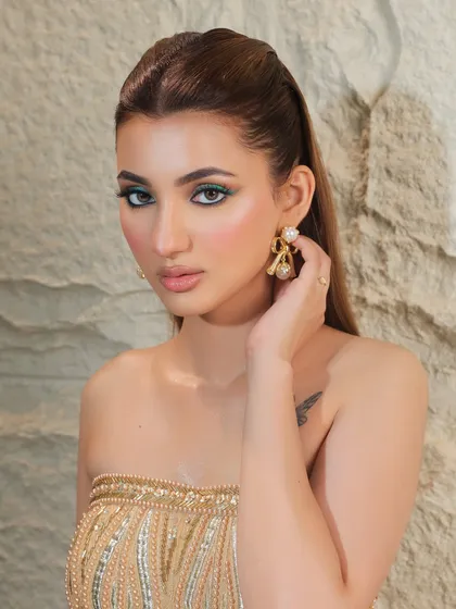 A full look featuring the chic green glitter liner, paired with a gold strapless dress.