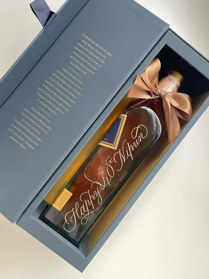 A Johnnie Walker Blue Label bottle, beautifully engraved for a 40th birthday. The large, flowing script makes a bold statement on this premium gift. I'm too obsessed to caption this.