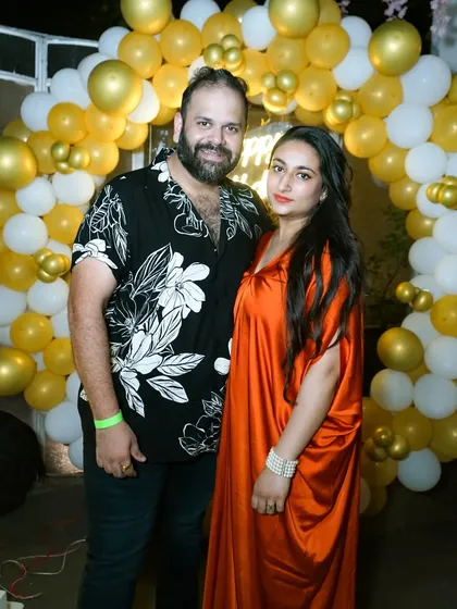A couple posing for a photo at a birthday celebration. We also capture great photos of the guests and hosts at your party.