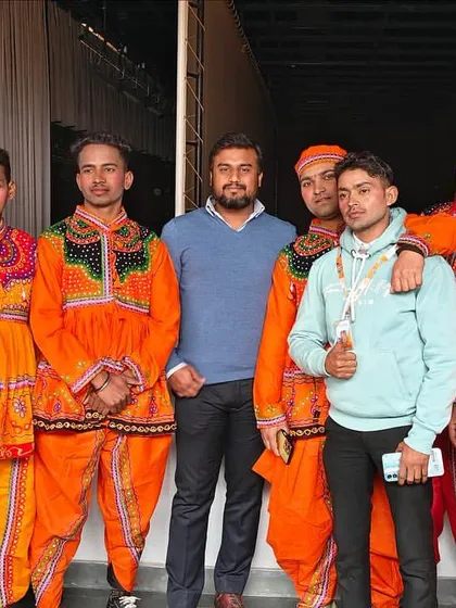 With another group of folk dancers in traditional Gujarati attire. I can incorporate cultural performances from various regions of India to suit your event's theme.
