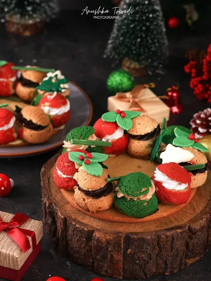 A wreath made of festive cream puffs. This is such a creative holiday dessert, and I styled it with gift boxes and ornaments to make it the centerpiece of a Christmas celebration.