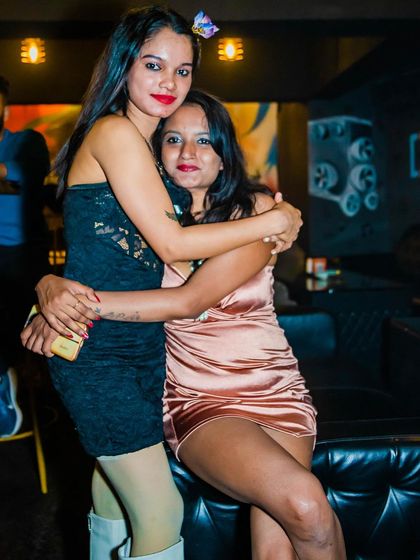Two friends hugging and enjoying the party.